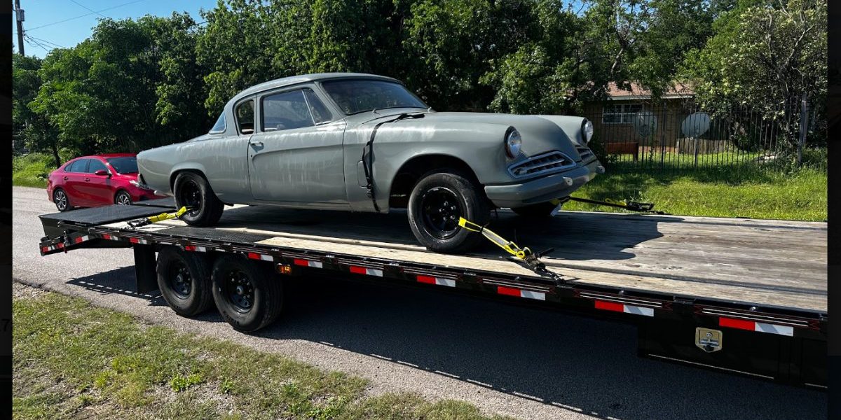 A classic car strapped down on Hillstar Logistics open gooseneck deck in Central Texas.